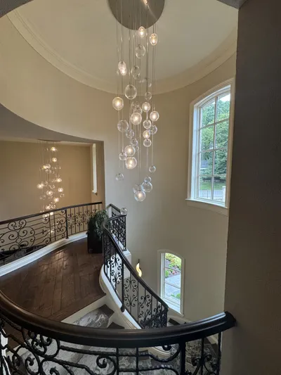 Chandelier and light fixture cleaning by Sparkle Window Cleaners — Chandelier + staircase + clean windows, hardwood.
