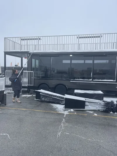 Professional window cleaning by Sparkle Window Cleaners — Crew cleaning large vehicle/trailer windows with pole