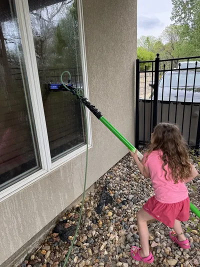 Professional window cleaning by Sparkle Window Cleaners — Isla using a water-fed pole on exterior windows