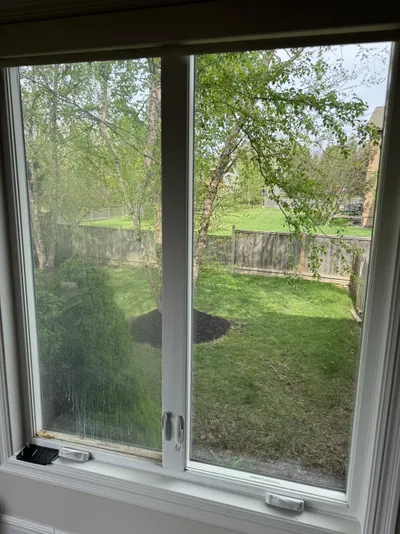 Professional window cleaning by Sparkle Window Cleaners — Pristine sliding glass door onto backyard.